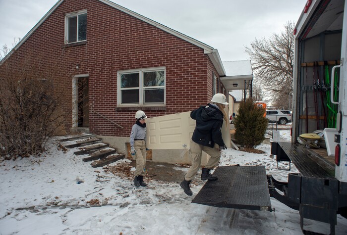 (Rick Egan  |  The Salt Lake Tribune)       Tierra Pouttu-Clarke and Taylor Drake from AmeriCorps, removes a closet door from a home that will be demolished for freeway widening, for UDOT and Habitat for Humanity, Wednesday, Jan. 16, 2019.





