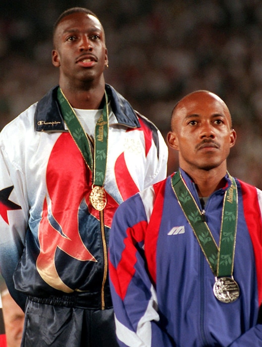 FILE - This is a Thursday Aug. 1, 1996 file photo of Frankie Fredericks of Namibia, right, wearing his silver medal with Michael Johnson of the United States, wearing his gold medal, during the presentation ceremony for the men's 200 meters at the 1996 Summer Olympic Games in Atlanta. Former Olympic sprinter Frankie Fredericks has turned himself over to the IOC ethics commission following a French newspaper report linking him to a payment from a man who has been banned for life from track and field for corruption. Le Monde reported Friday March 3, 2017, that a payment of $299,300 to an offshore company linked to Fredericks came in 2009 on the day that Rio de Janeiro was awarded hosting rights for the 2016 Olympics. (AP Photo/Eric Draper/File )