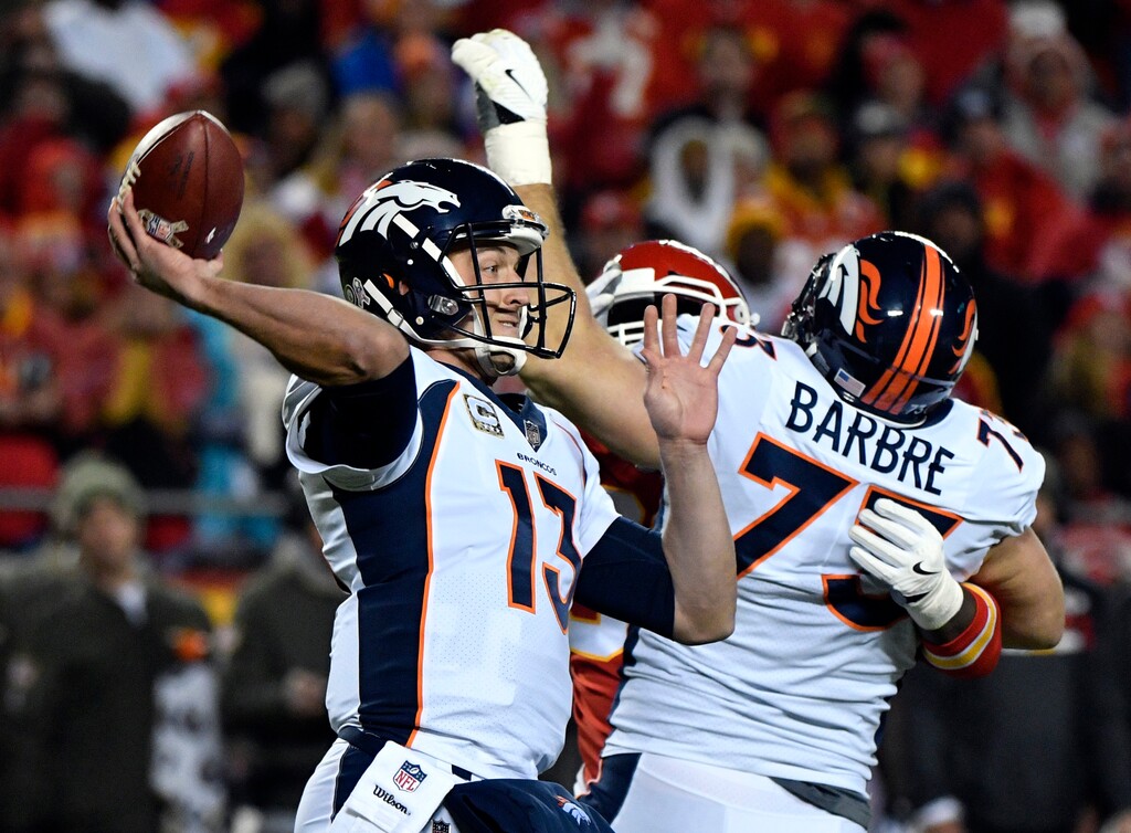 Denver Broncos quarterback Trevor Siemian (13) throws a ball which was intercepted by Kansas City Chiefs defensive back Marcus Peters during the first half of an NFL football game in Kansas City, Mo., Monday, Oct. 30, 2017. (AP Photo/Ed Zurga)