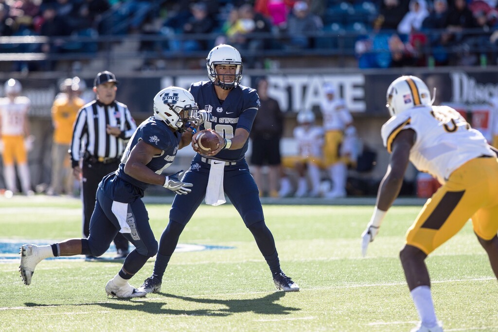 (Courtesy Utah State University athletics) Utah State quarterback Jordan Love hands off during the Aggies' game against Wyoming on Saturday.