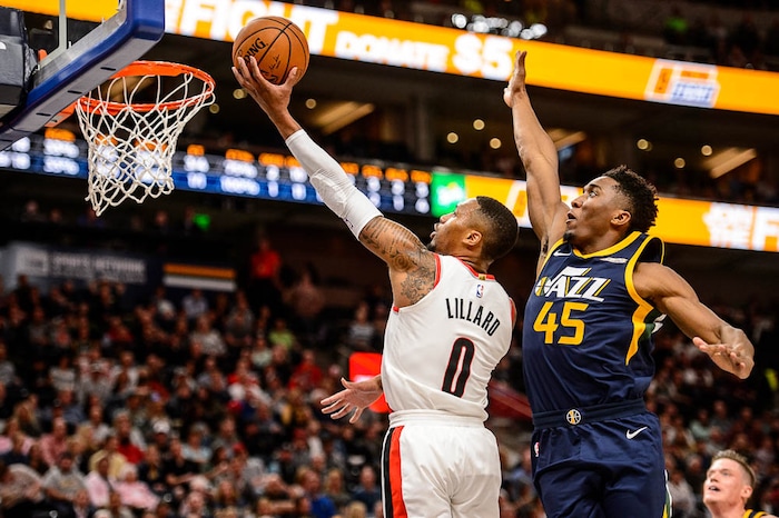 (Trent Nelson | The Salt Lake Tribune)  Portland Trail Blazers guard Damian Lillard (0) shoots with Utah Jazz guard Donovan Mitchell (45) trailing, as the Utah Jazz host the Portland Trail Blazers, NBA basketball in Salt Lake City, Wednesday November 1, 2017.