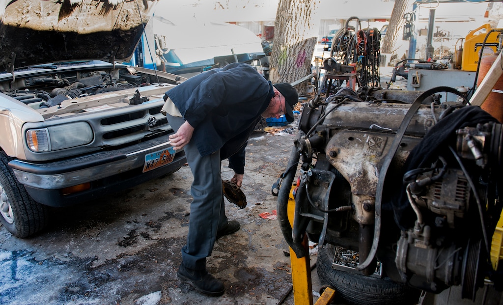 (Leah Hogsten  |  The Salt Lake Tribune) Ondi Williamson services and repairs vehicles for a living now at his full service garage attached to his home in Nephi. Williamson suffers from PTSD and depression stemming from the 2002 vehicle collision that killed his wife Thanh Williamson, injured himself and his daughter Alexa. The accident set a precedent-setting decision by the U.S. Supreme Court on seatbelt safety requirements.