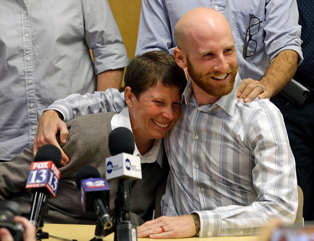 FILE - In this Oct. 6, 2014, file photo, Kody Partridge, left, and Derek Kitchen, two of the six people who brought the lawsuit against Utah's gay marriage ban, speak during a news conference in Salt Lake City. Salt Lake City Councilman Kitchen edged closer to victory Friday, July 6, 2018, in his Democratic primary race in one of the state Senate's few liberal districts. (AP Photo/Rick Bowmer, File)