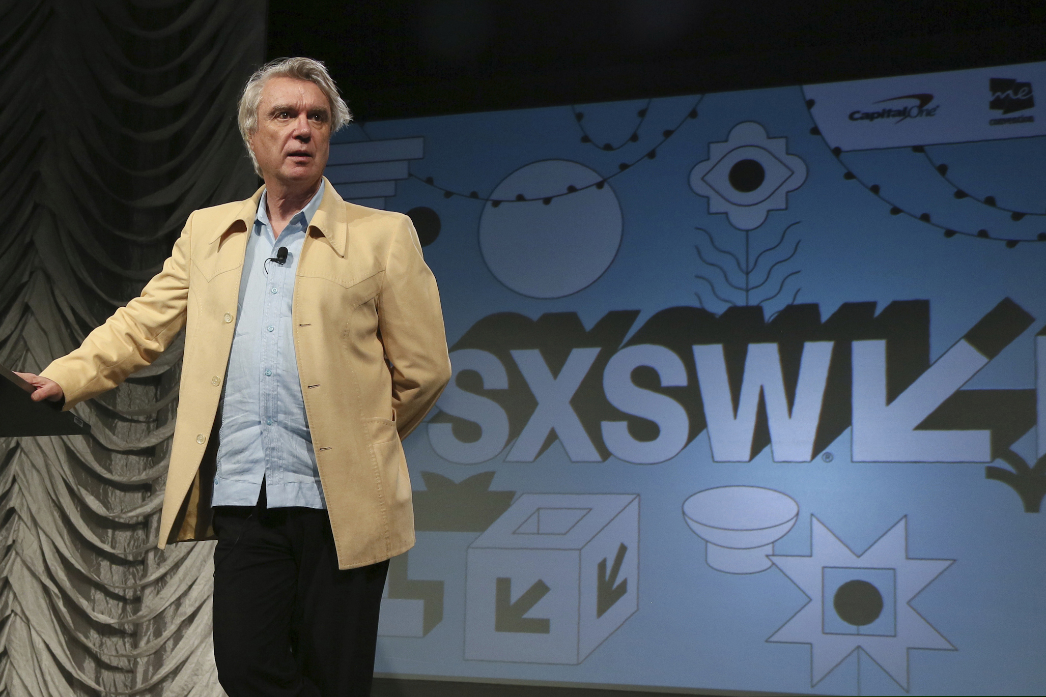 David Byrne takes part in the "Reasons To Be Cheerful" featured session during the South by Southwest Music Festival in Austin, Texas, on March 13, 2019. Austin city officials have canceled the South by Southwest arts and technology festival. Mayor Steve Adler announced a local emergency that effectively canceled the annual event. (Photo by Jack Plunkett/Invision/AP, File)