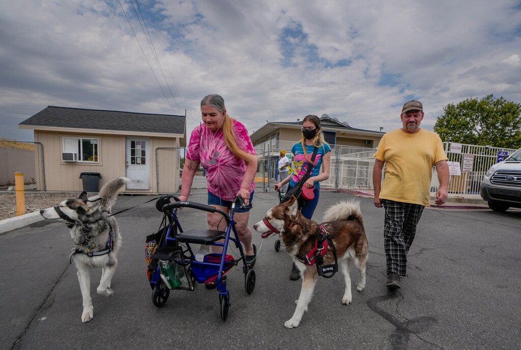 (Francisco Kjolseth  | The Salt Lake Tribune) Daniel Eastman (51), a full-time caregiver for his wife Michelle (63), and daughter Amiya (20), both of whom have rare, debilitating health conditions that require daily medical support that shelters can’t provide, visit with one another briefly outside of the Ville supportive housing on Friday, July 18, 2025. Daniel who isn’t allowed to stay with them at housing in Salt Lake, is staying in shelters, cheap hotels or camping as he looks for work. 