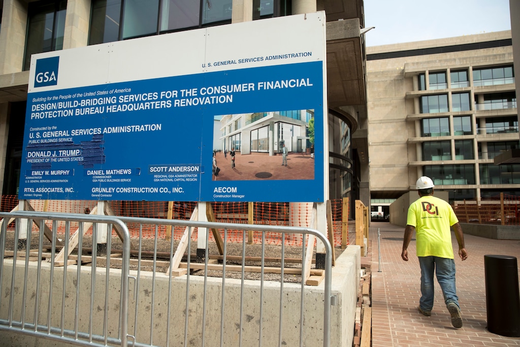 A sign stands at the construction site for the Consumer Financial Protection Bureau's new headquarters in Washington, Monday, Aug. 27, 2018. Seth Frotman, the nation's top government official overseeing the $1.5 trillion student loan market resigned on Monday, citing what he says is the White House's open hostility toward protecting student loan borrowers. Frotman is the latest high-level departure from the CFPB since Mick Mulvaney took over in late November. (AP Photo/Andrew Harnik)
