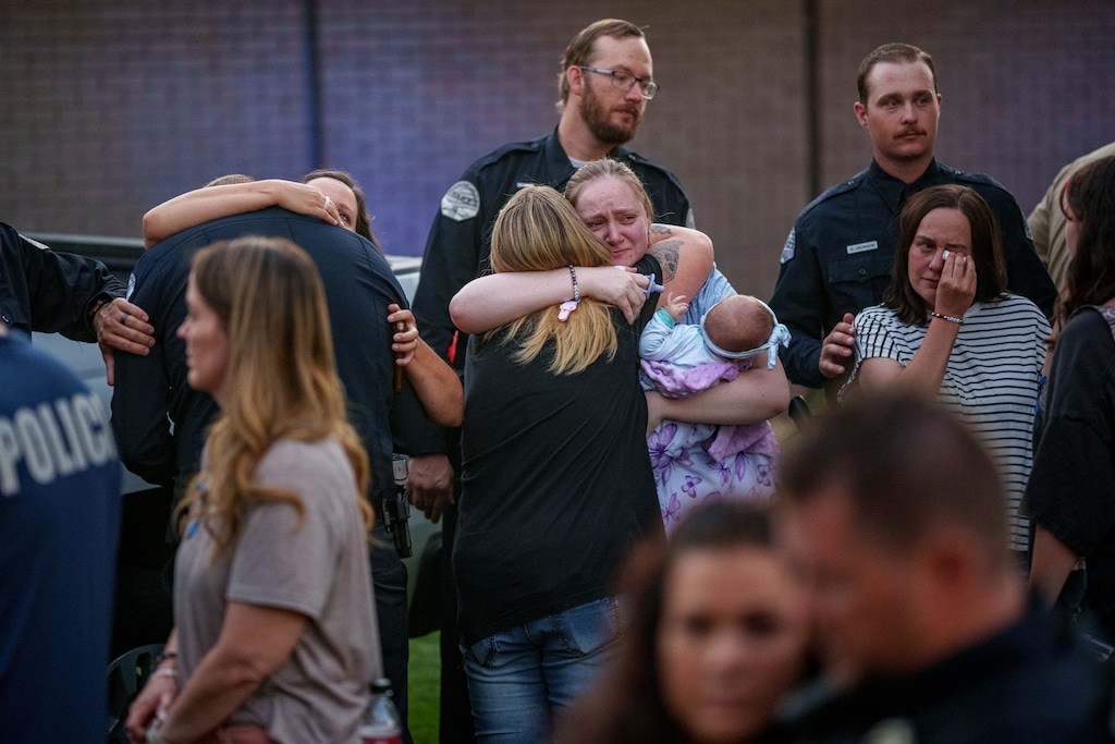 (Trent Nelson  |  The Salt Lake Tribune) Police officers and family members at a vigil in Tremonton on Tuesday, Aug. 19, 2025, to honor two city police officers who were killed and a sheriff’s deputy who was wounded two days earlier in a shooting.