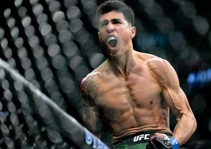 (Francisco Kjolseth | The Salt Lake Tribune) Luis Saldan of the United States jumps on the fence to celebrate his win over Sean Woodson of the United States in their featherweight bout at Vivint Arena for UFC 278 on Saturday, Aug. 20, 2022. 