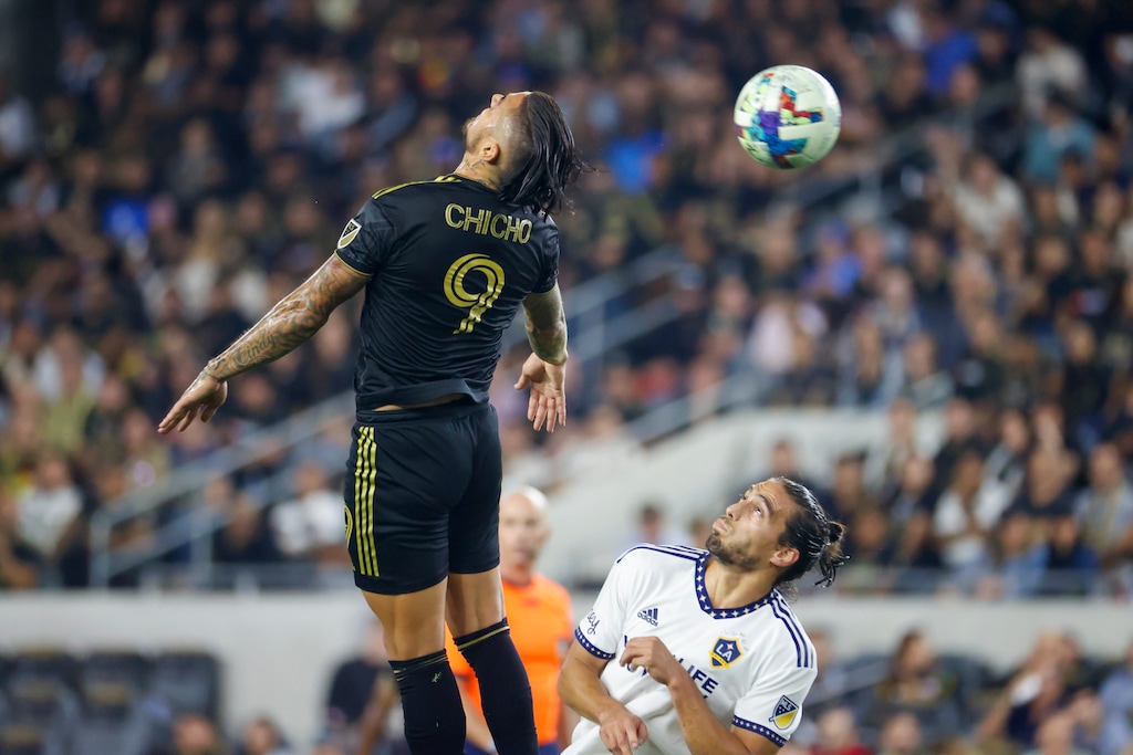 (Ringo H.W. Chiu | AP) Former Los Angeles FC forward Cristian Arango (9) goes up for the ball against LA Galaxy defender Martin Caceres (22) during the second half of an MLS playoff soccer match on Thursday, Oct. 20, 2022, in Los Angeles. Los Angeles FC won 3-2.
