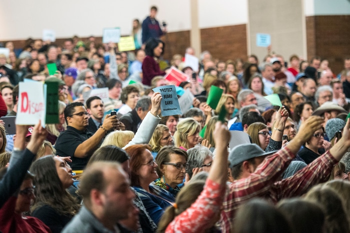 Chris Detrick  |  The Salt Lake Tribune
Members of the audience hold up signs as U.S. Rep. Jason Chaffetz, R-Utah, speaks during the town-hall meeting in Brighton High School Thursday February 9, 2017. 