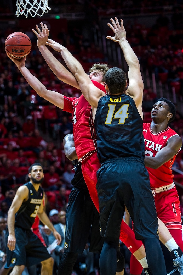 (Chris Detrick  |  The Salt Lake Tribune)   Utah Utes forward Jayce Johnson (34) shoots past Missouri Tigers forward Reed Nikko (14) during the game at the Jon M. Huntsman Center Thursday, November 16, 2017.   