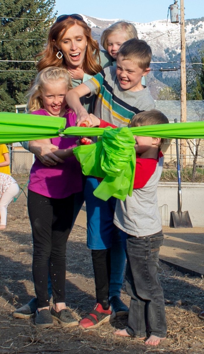 (Rick Egan | The Salt Lake Tribune)  Jenny Taylor and her kids, Red sleeves Jonathan, Jacob, Eleanor and Caroline
Cut the ribbon, during the Earth Day Party at the Mini Taylor farm at at the Jennie Taylor's residence, in North Ogden. Taylor is the widow to the late Major. Brent Taylor, killed in 2018 while on Army National Guard duty in Afghanistan, donations have helped restore the small family farm, with planter boxes, a chicken coop, and a sandbox for the kids, on Thursday, April 22, 2021.