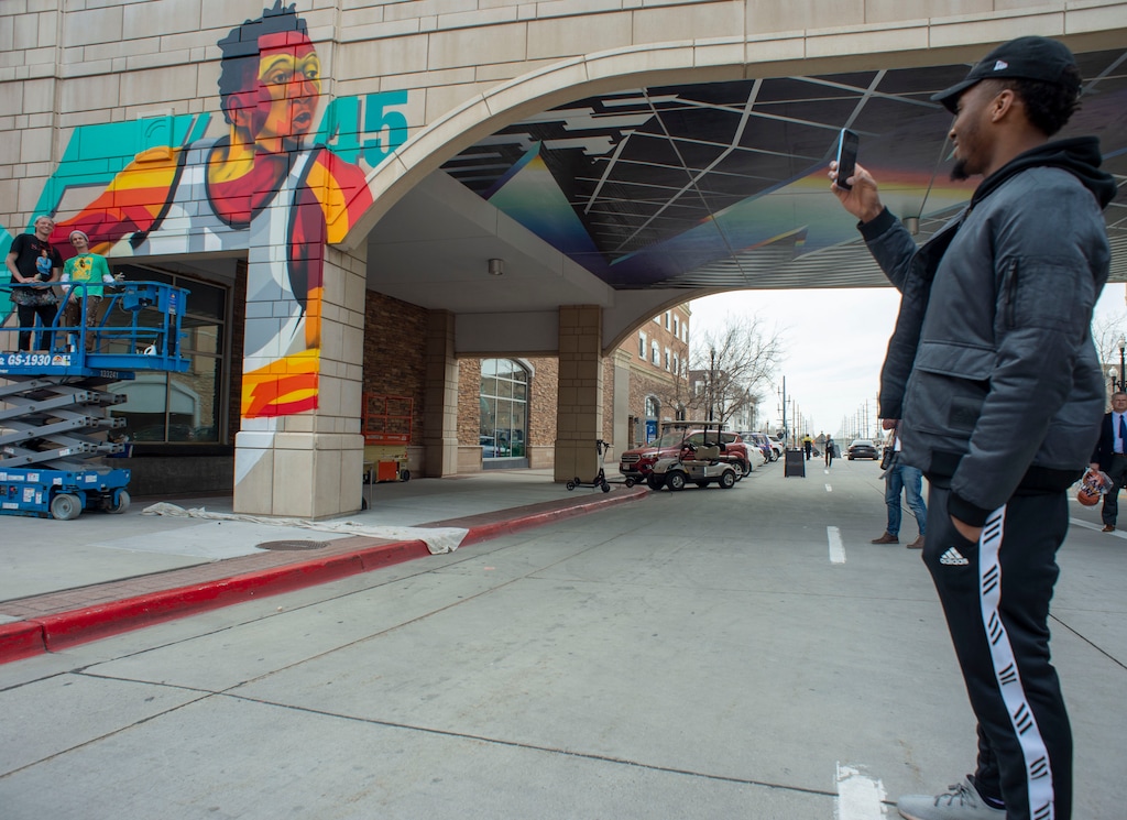 (Rick Egan | The Salt Lake Tribune) Donovan Mitchell snaps a photo of his mural before the dedication of the Donovan Mitchell Bridge at the Gateway in Downtown Salt Lake, Tuesday, March 26, 2019.