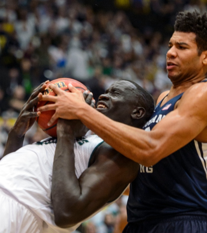 (Steve Griffin  |  The Salt Lake Tribune) Brigham Young Cougars forward Yoeli Childs (23) ties up Utah Valley Wolverines center Akolda Manyang (0) during the BYU versus UVU basketball game at UCCU Center on the UVU campus in Orem Wednesday November 29, 2017.