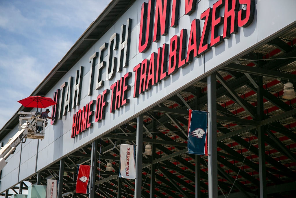 (Jud Burkett | Special to The Tribune) Crews install a “Utah Tech” sign on the east side of Greater Zion Stadium in 2022.