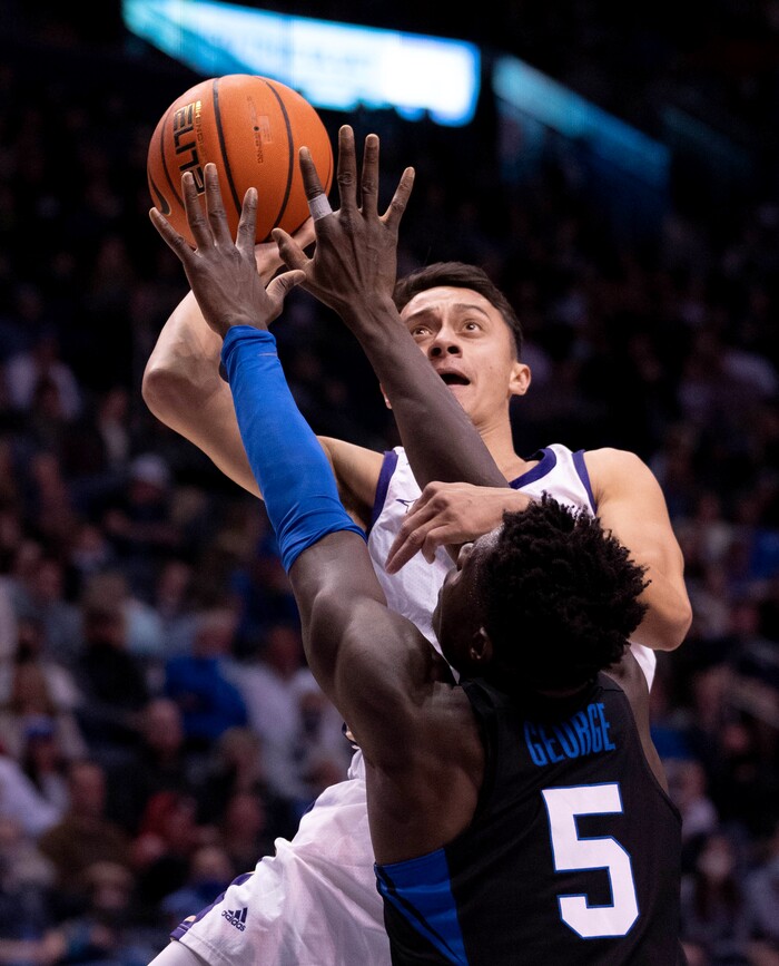 (Francisco Kjolseth | The Salt Lake Tribune) Westminster Griffins guard Taylor Miller (3) tries to get past Brigham Young Cougars forward Gideon George (5) in basketball action between the Brigham Young Cougars and the Westminster Griffins at the Marriott Center in Provo, Wednesday, Dec. 29, 2021.