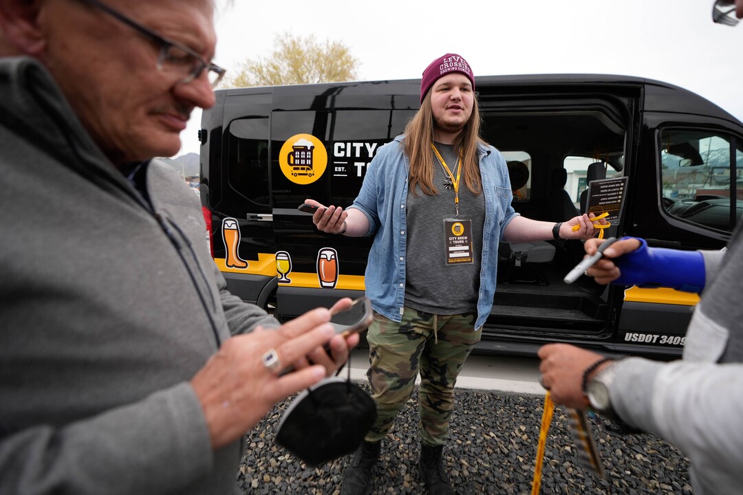 (Francisco Kjolseth | The Salt Lake Tribune) Liam Bice, tour guide with City Brew Tours in Salt Lake City gets ready to take people to four local breweries to see the back end brewing process, sample beers and pair them with food on Saturday, April 30, 2022. 