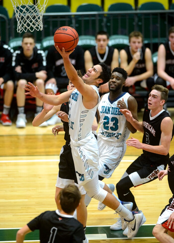 (Steve Griffin | The Salt Lake Tribune) Juan Diego's Raimoana Tinirauarii (11) gets free for a basket during 4A basketball playoff game against Hurricane at the Utah Valley UniversityÕs UCCU Center in Provo Thursday March 1, 2018.