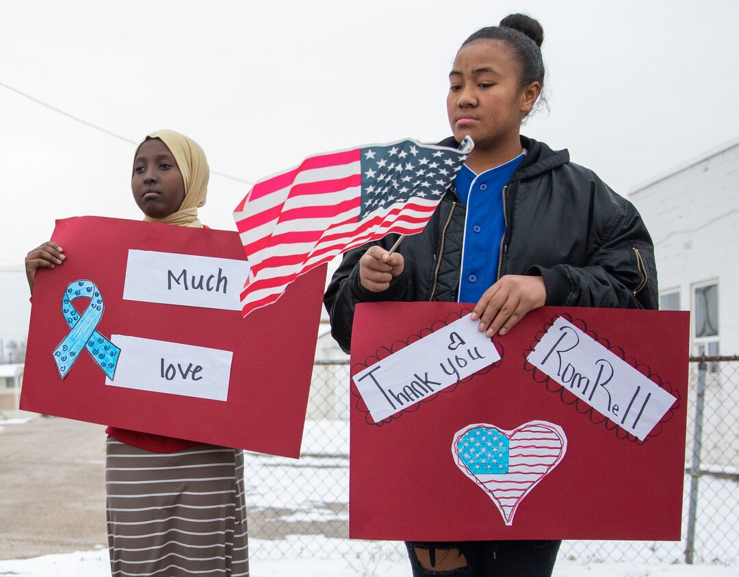 (Keith Johnson  |  special to The Salt Lake Tribune) Granite Park Junior High eighth graders Monalani Siliga (right) and Munila Abdullahi join nearly 500 of their classmates and staff as they line State Street near 3000 South to show their support and watch the funeral procession for Officer David Romrell Dec. 5, 2018 in South Salt Lake, Utah. Officer Romrell, a South Salt Lake police officer, was killed in the line of duty Nov. 24th when he was struck by a car driven by a fleeing suspect. 