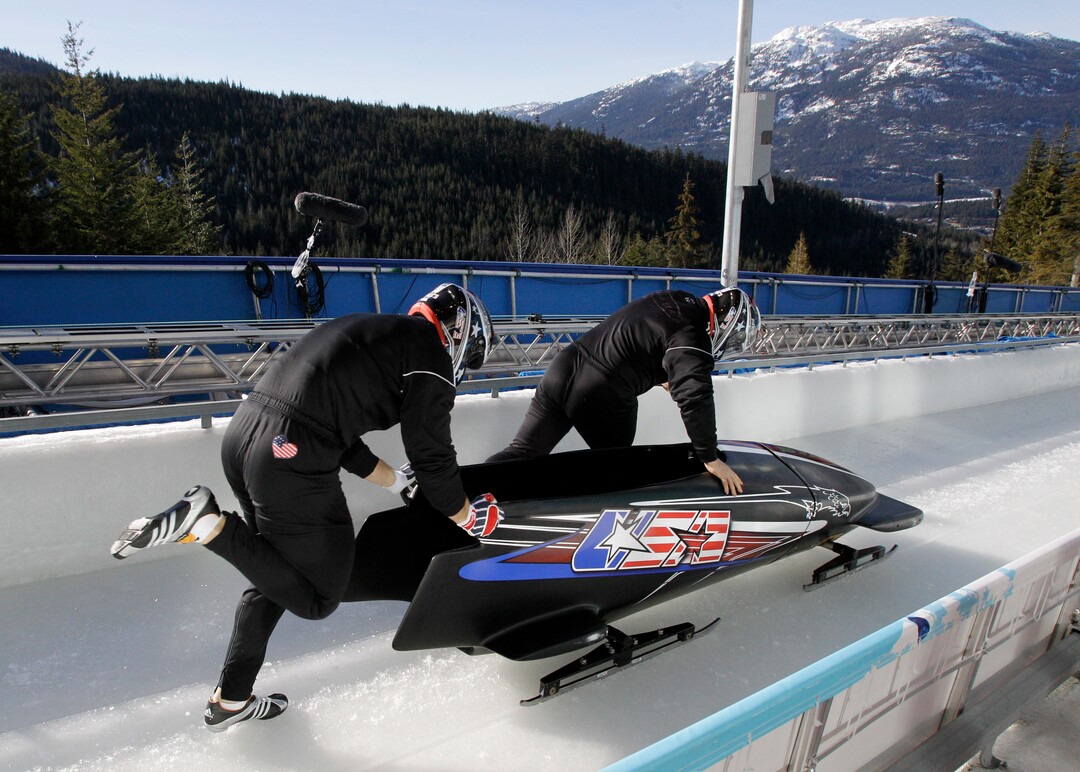 The United States' USA-1, piloted by Steven Holcomb, right, and his brakeman Curtis Tomasevicz, practice during a men's two-man bobsled training run at the Vancouver 2010 Olympics in Whistler, British Columbia, Thursday, Feb. 18, 2010. (AP Photo/Michael Sohn)