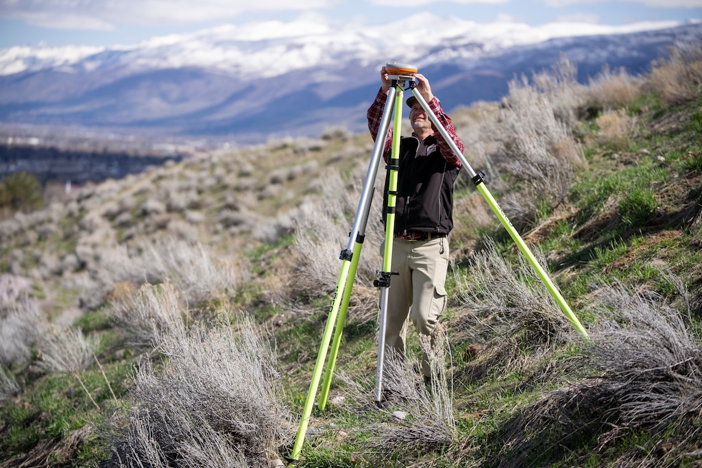 (Rick Egan | The Salt Lake Tribune) 
Geologist Ben Erickson of the Utah Geological Survey adjusts the GPS equipment that monitors landslides at the Springhill Geologic Park in North Salt Lake, on Wednesday, April 19, 2023. A creeping landslide destroyed 18 homes here several years ago.