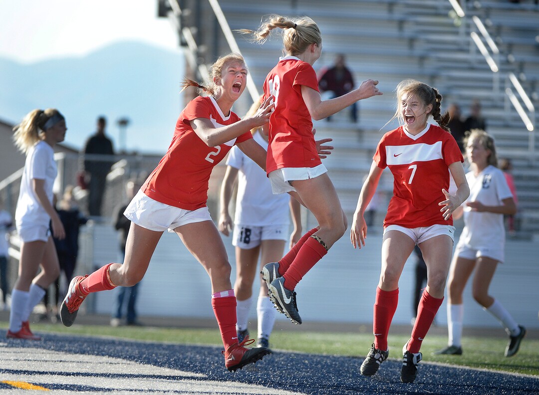 (Scott Sommerdorf   |  The Salt Lake Tribune)   East forward Emily Jensen, center, celebrates with team mates Charlie Barta, left, and Erin Bridges, right after Jensen's header gave East a 1-0 lead against Corner Canyon during first half play. East beat Corner Canyon 4-1 in a Class 5A girls' soccer state quarterfinal, Thursday, October 12, 2017. 