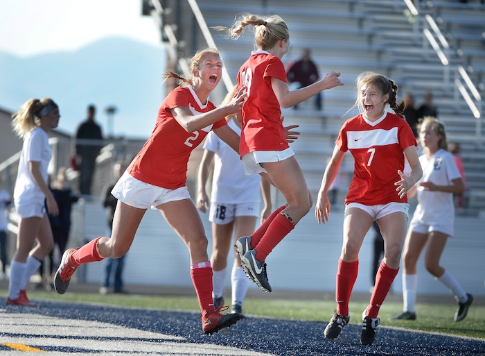 (Scott Sommerdorf   |  The Salt Lake Tribune)   East forward Emily Jensen, center, celebrates with team mates Charlie Barta, left, and Erin Bridges, right after Jensen's header gave East a 1-0 lead against Corner Canyon during first half play. East beat Corner Canyon 4-1 in a Class 5A girls' soccer state quarterfinal, Thursday, October 12, 2017. 