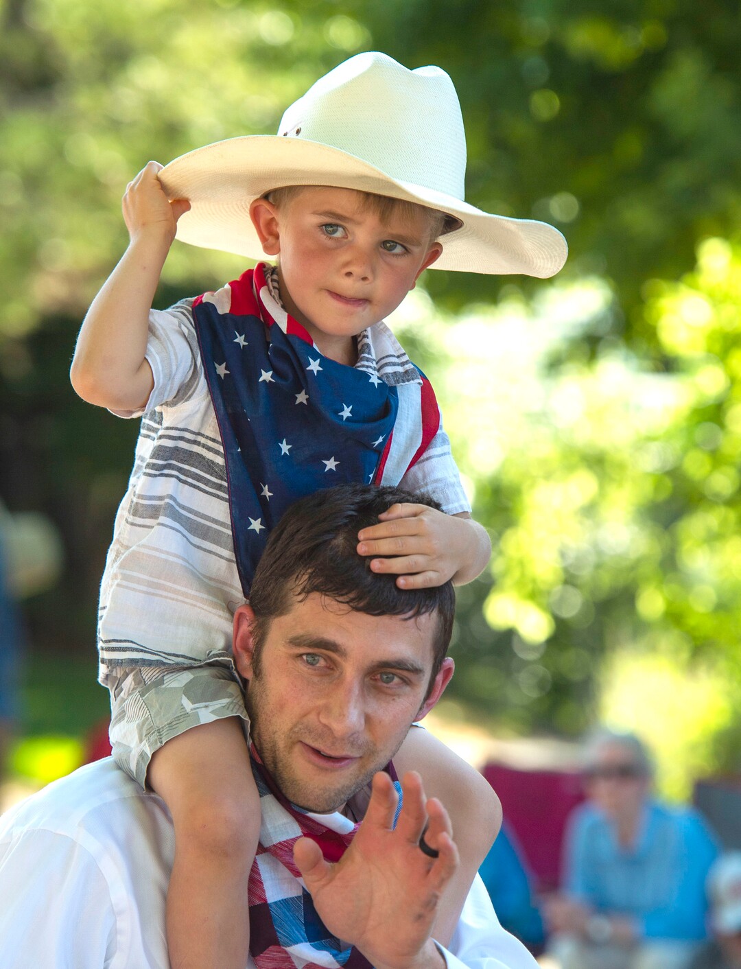 (Rick Egan  |  The Salt Lake Tribune)    Brandon Cardon waves to the crowd, as he walks with his 4-year-old son Liam on his shoulders, in the Bountiful Handcart Days Parade, Friday, July 19, 2019.