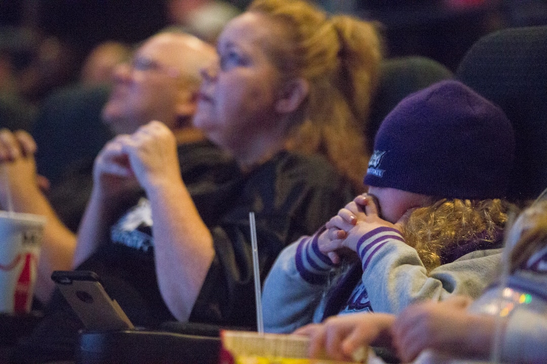 Izzy Baxter, 9, covers her face with her beanie while watching television coverage of Weber State playing James Madison in the quarterfinals of the FCS NCAA college football playoffs, Friday, Dec. 8, 2017, in Ogden, Utah. (Matt Herp/Standard-Examiner via AP)
