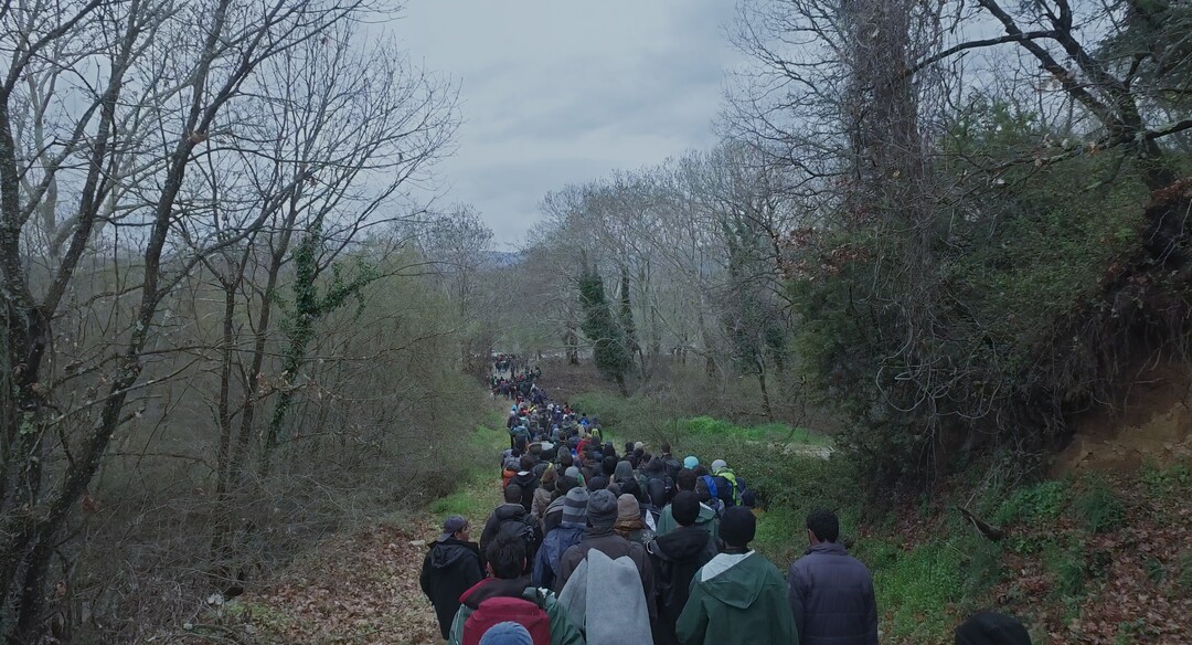 (Courtesy Amazon Studios) Refugees walking near Idomeni Camp, in northern Greece, in a scene from Ai Weiwei's documentary "Human Flow."