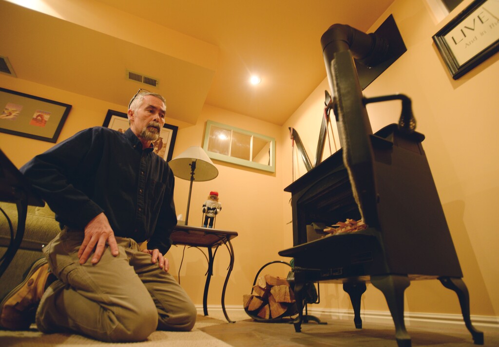 (Steve Griffin | Tribune file photo) Sugar House resident Scott Thomas, shown with his clean-burning Lipo Parlor wood stove in 2015. The U.S. Environmental Protection Agency announced Wednesday that Utah will receive nearly $13 million for Provo, Salt Lake City and Logan, to fund exchange programs for inefficient wood-burning devices and take other steps in hopes of improving air quality.