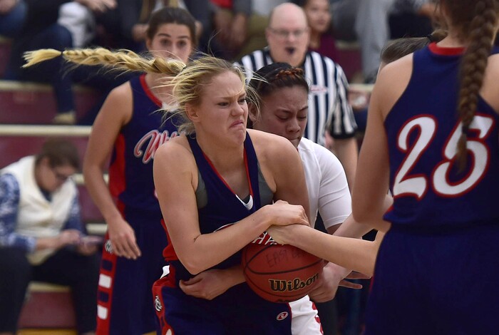 (Scott Sommerdorf   |  The Salt Lake Tribune)   Woods Cross's Rachel Noel grits out a battle for a loose ball during first half play. East beat Woods Cross 50-36, Friday, December 15, 2017.  