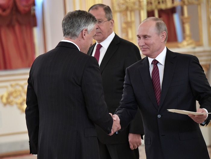 3205042 10/03/2017 October 3, 2017. Russian President Vladimir Putin and Ambassador Extraordinary and Plenipotentiary of the USA to Russia Jon Meade Huntsman, left, at a ceremony to present letters of credence in the Alexander Hall of the Grand Kremlin Palace. Background: Russian Foreign Minister Sergei Lavrov. Aleksey Nikolskyi/Sputnik  via AP