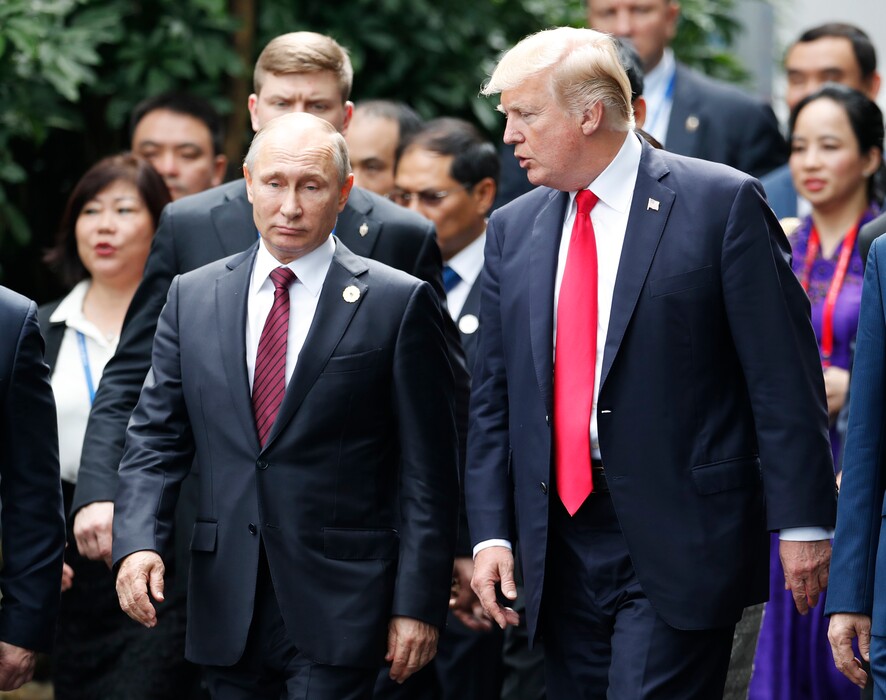 U.S. President Donald Trump, right, and Russia's President Vladimir Putin talk during the family photo session at the APEC Summit in Danang, Vietnam Saturday, Nov. 11, 2017. Trump and Putin may not be having a formal meeting while they’re in Vietnam for an economic summit. But the two appear to be chumming it up nonetheless. Snippets of video from the Asia-Pacific Economic Cooperation conference Saturday have shown the leaders chatting and shaking hands at events including a world leaders’ group photo. (Jorge Silva/Pool Photo via AP)