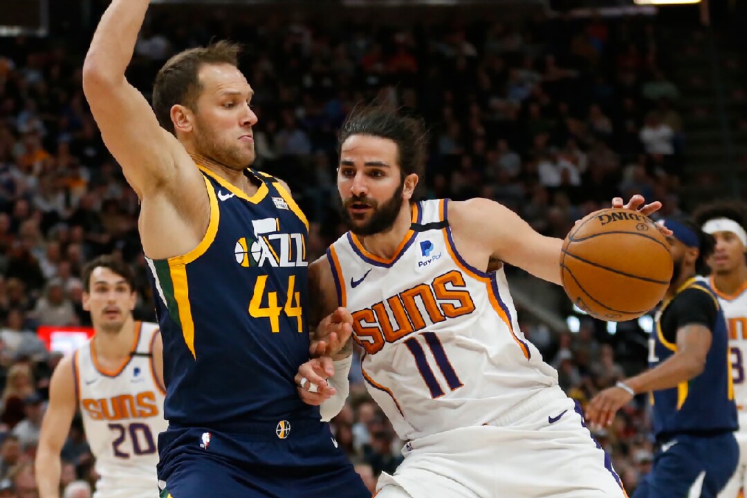 Phoenix Suns guard Ricky Rubio (11) drives against Utah Jazz forward Bojan Bogdanovic (44) in the second half during an NBA basketball game Monday, Feb. 24, 2020, in Salt Lake City. (AP Photo/Rick Bowmer)