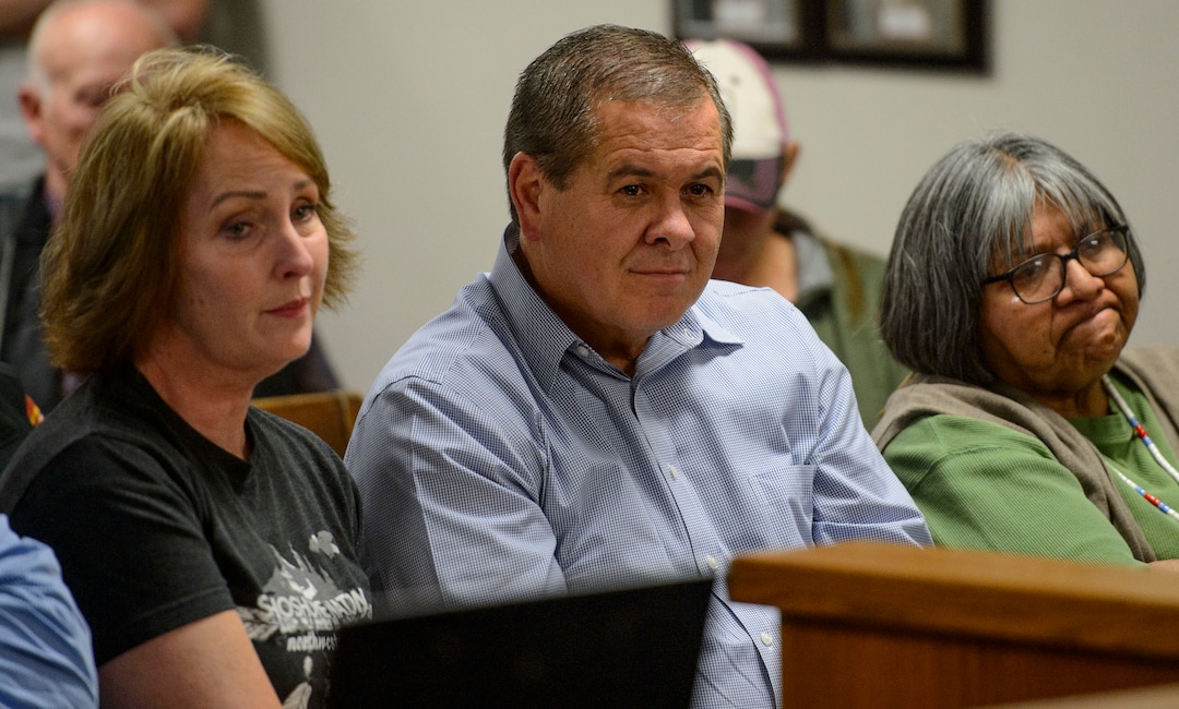 (Steve Griffin  |  The Salt Lake Tribune) Northwest Band Tribal Council Chairman Darren Parry, center, listens as Wellsville City Councilman, Carl Leatham, tells hime that he participated in the Sham Battle for 18 years and said that he thought it was an honor to portrait Native Americans in the battle when he was in it. Leatham also apologized to Parry saying he meant no disrespect and his participation in the event was not meant to offend anyone. Earlier in the city council meeting, at the Wellsville City Hall, in Wellsville, Utah Wednesday September 20, 2017, Parry addressed the council about his concerns about the Sham Battle. The mayor and the city council created a committee to decide the future of the Sham Battle where white residents paint their bodies red, put on war paint, and whoop and fire guns, attacking the humble settlers before being driven off by the cavalry troops. 