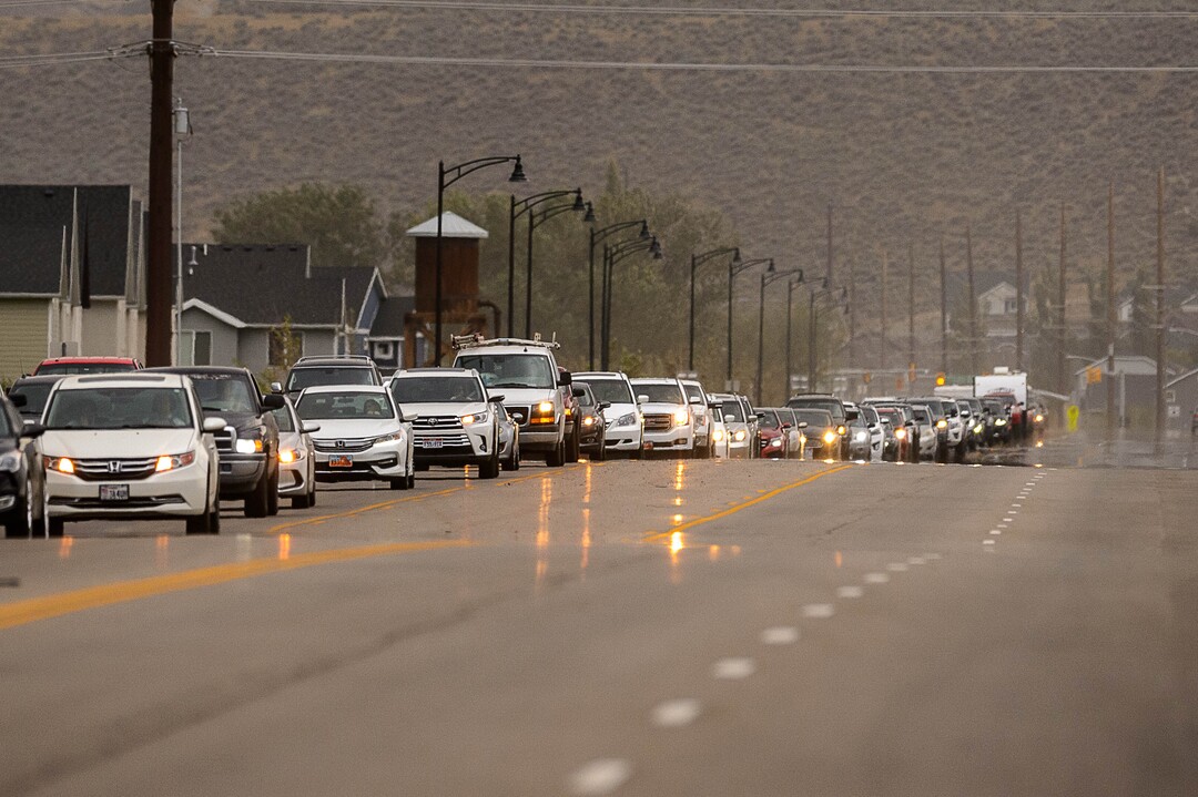 (Trent Nelson  |  The Salt Lake Tribune) A long line of cars driving north out of the area as the Knolls Fire burns above Saratoga Springs on Sunday, June 28, 2020.