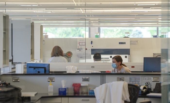 (Francisco Kjolseth | The Salt Lake Tribune) DNA Analysts work behind closed doors in an extraction clean room at the office of the medical examiner in Taylorsville where rape kits are being processed on Wed. June 6, 2018. A new tracking system provides sexual assault survivors with the ability to anonymously track the location and status of their Sexual Assault Kit from point of collection through forensic analysis. The tracking system provides real-time information to sexual assault survivors regardless of when and where their sexual assault kit was collected in the state of Utah.