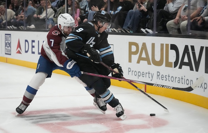 (Bethany Baker | The Salt Lake Tribune) Utah Hockey Club center Clayton Keller (9) vies for the puck with Colorado Avalanche defenseman Devon Toews (7) during the game between the Utah Hockey Club and the Colorado Avalanche at the Delta Center in Salt Lake City on Thursday, Oct. 24, 2024.