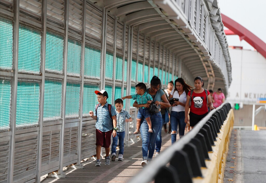(Rebecca Blackwell | AP file photo) Residents with visas walk across the Puerta Mexico international bridge on June 28, 2019, to enter the U.S., in Matamoros, Tamaulipas state, Mexico. A federal judge in Portland, Ore., on Saturday, Nov. 2, 2019, put on hold a Trump administration rule requiring immigrants prove they will have health insurance or can pay for medical care before they can get visas. U.S. District Judge Michael Simon granted a preliminary injunction that prevents the rule from going into effect Sunday.