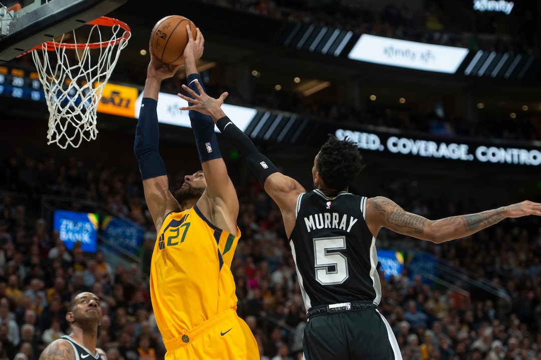 (Rick Egan  |  The Salt Lake Tribune)    Utah center Rudy Gobert (27) gets past San Antonio Spurs guard Dejounte Murray (5) to score for the Jazz, in NBA action between the Utah Jazz and the San Antonio Spurs, in Salt Lake City, Friday, Feb. 21, 2020.