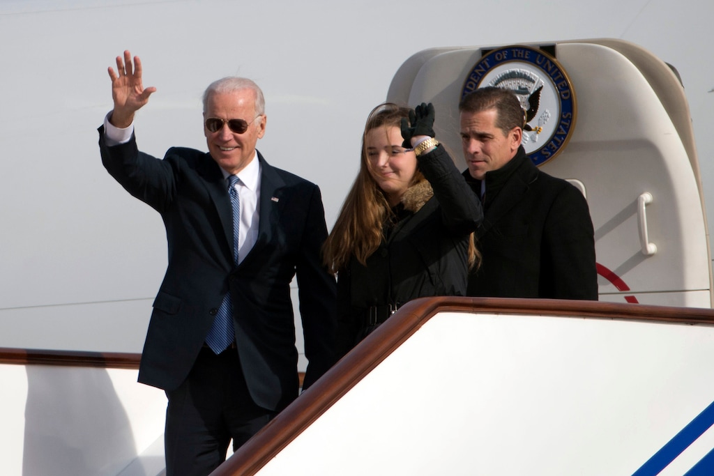 (Ng Han Guan | AP file photo) Then-U.S. Vice President Joe Biden, left, waves as he walks out of Air Force Two with his granddaughter Finnegan Biden and son Hunter Biden at the airport in Beijing, China, in December 2013.
