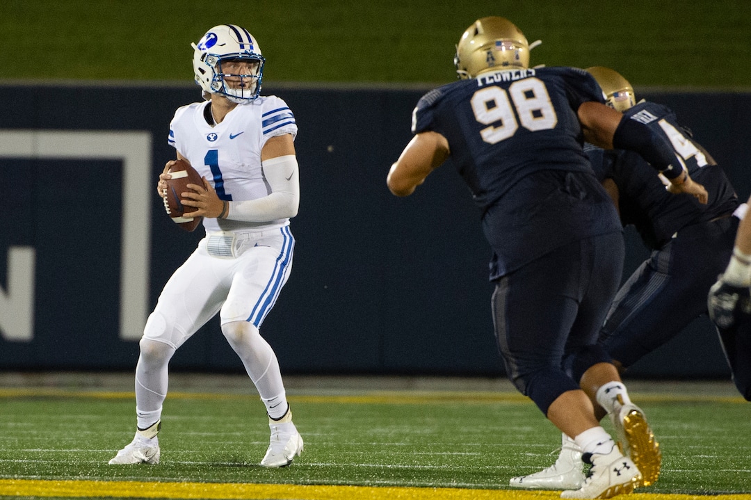 BYU quarterback Zach Wilson (1) looks to throw as Navy guard Mike Flowers (98) applies pressure during the first half of an NCAA college football game, Monday, Sept. 7, 2020, in Annapolis, Md. (AP Photo/Tommy Gilligan)