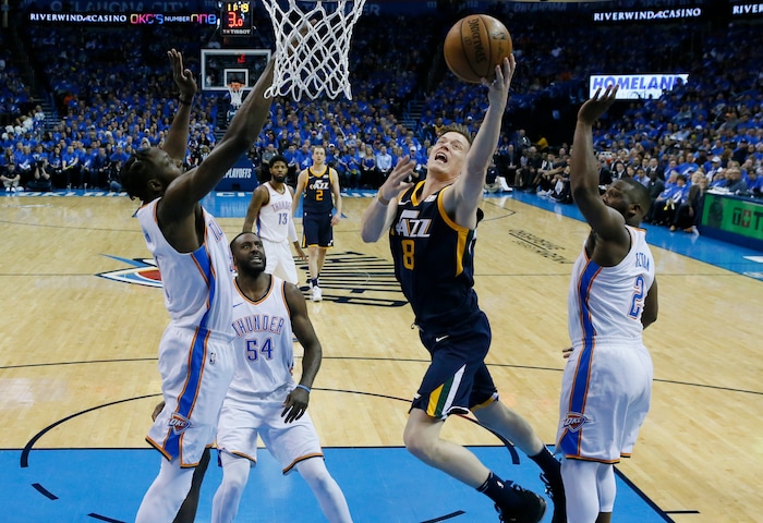 Utah Jazz forward Jonas Jerebko (8) shoots between Oklahoma City Thunder forward Jerami Grant, left, forward Patrick Patterson (54) and guard Raymond Felton (2) in the first half of Game 1 of an NBA basketball first-round playoff series in Oklahoma City, Sunday, April 15, 2018. (AP Photo/Sue Ogrocki)