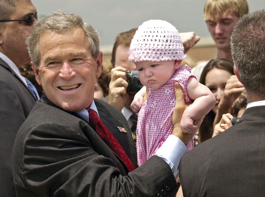 President Bush holds a baby as he greets visitors as he leaves Fort Smith, Ark. after speaking about his "No Child Left Behind" education law, in Van Buren, Ark., Tuesday, May 11, 2004. (AP Photo/Gerald Herbert)