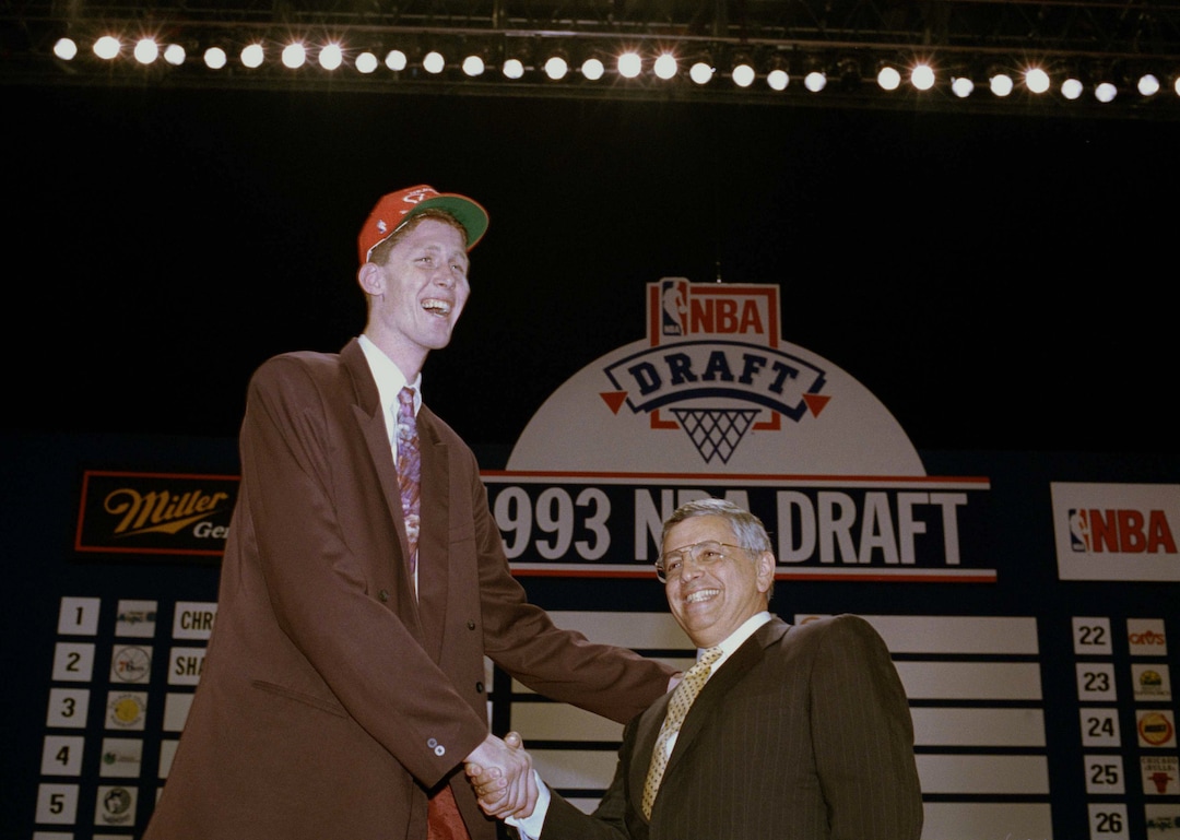 Brigham Young's Shawn Bradley shakes hands with NBA commissioner David Stern after being selected by the Philadelphia 76ers as the second pick in the 1993 NBA Draft, June 30, 1993 at the Palace in Auburn Hills, Mich. (AP Photo/Lennox McLendon)