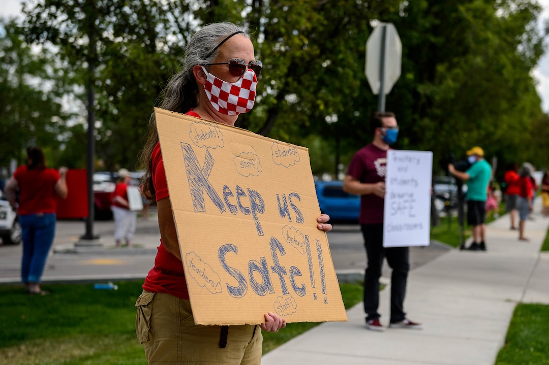 (Trent Nelson  |  The Salt Lake Tribune) Amy Harvey. a teacher at Heartland Elementary, joined other teachers and parents holding signs calling for a safe plan on reopening schools prior to a Jordan School District board meeting in Riverton on Tuesday, July 28, 2020.