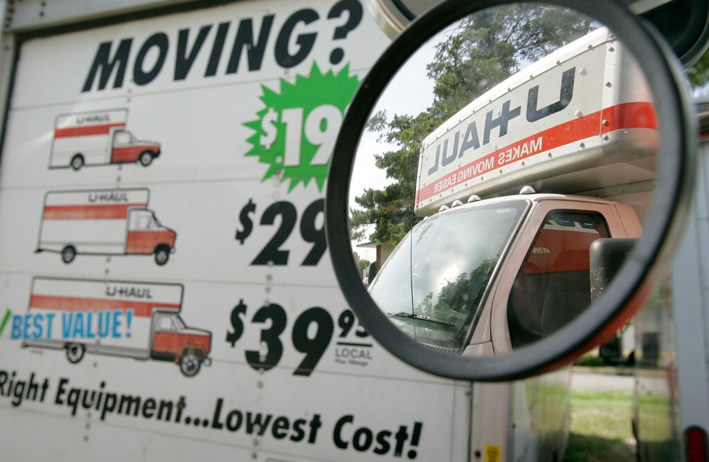 (Charlie Neibergal | AP file photo)  File) A U-Haul truck is seen in the side mirror of a another truck sitting on a dealer lot on June 14, 2006. New census estimates say one of every six Utahns moved last year.