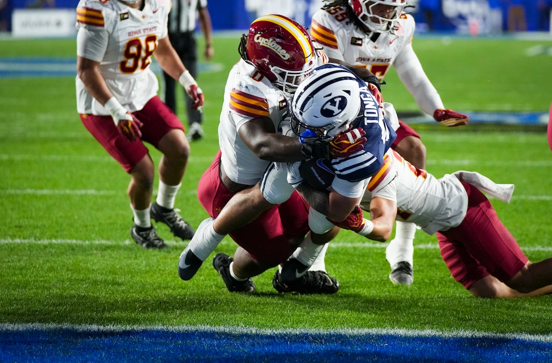 (Bethany Baker  |  The Salt Lake Tribune) BYU Cougars running back Journee Tonga (20) prepares to score a touchdown as Iowa State Cyclones running back Cameron Pettaway (0) blocks during the game between the BYU Cougars and the Iowa State Cyclones in Provo on Friday, Oct. 9, 2026.