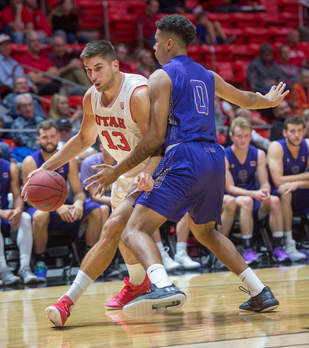 (Rick Egan  |  The Salt Lake Tribune)  Utah Utes forward Novak Topalovic (13) takes the ball inside, as Jalen Galloway (0) College of Idaho, defends, in basketball action, between the Utah Utes and the College of Idaho Yotes at the Jon M. Huntsman Center, Thursday, Nov. 1, 2018.